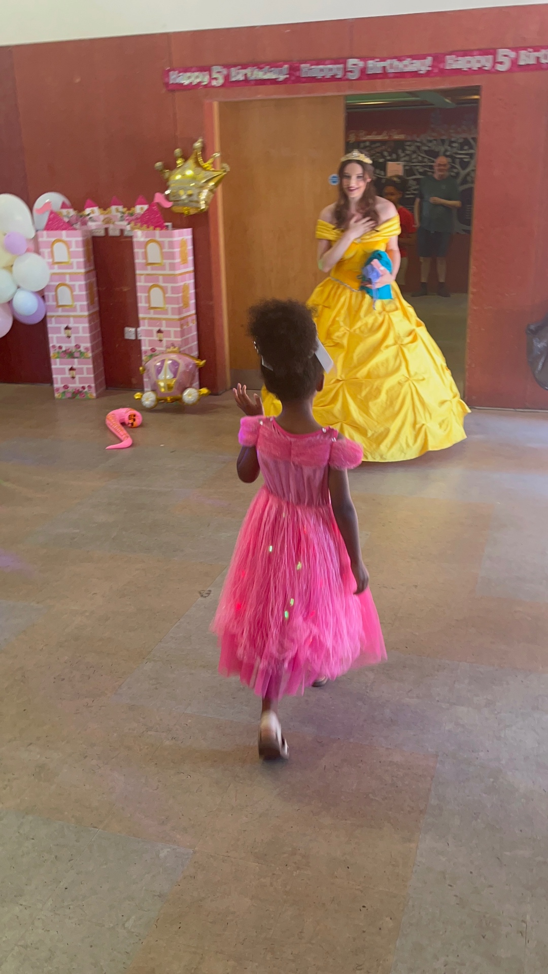 My daughter walking towards the princess at her fifth birthday party.